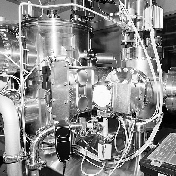 A black-and-white photograph of a complicated machine with tanks and wires