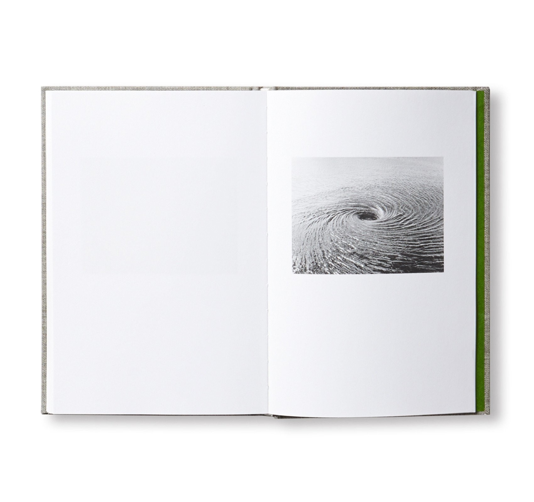 A photograph of a spread from a book with a picture of a whirlpool on the right-hand page