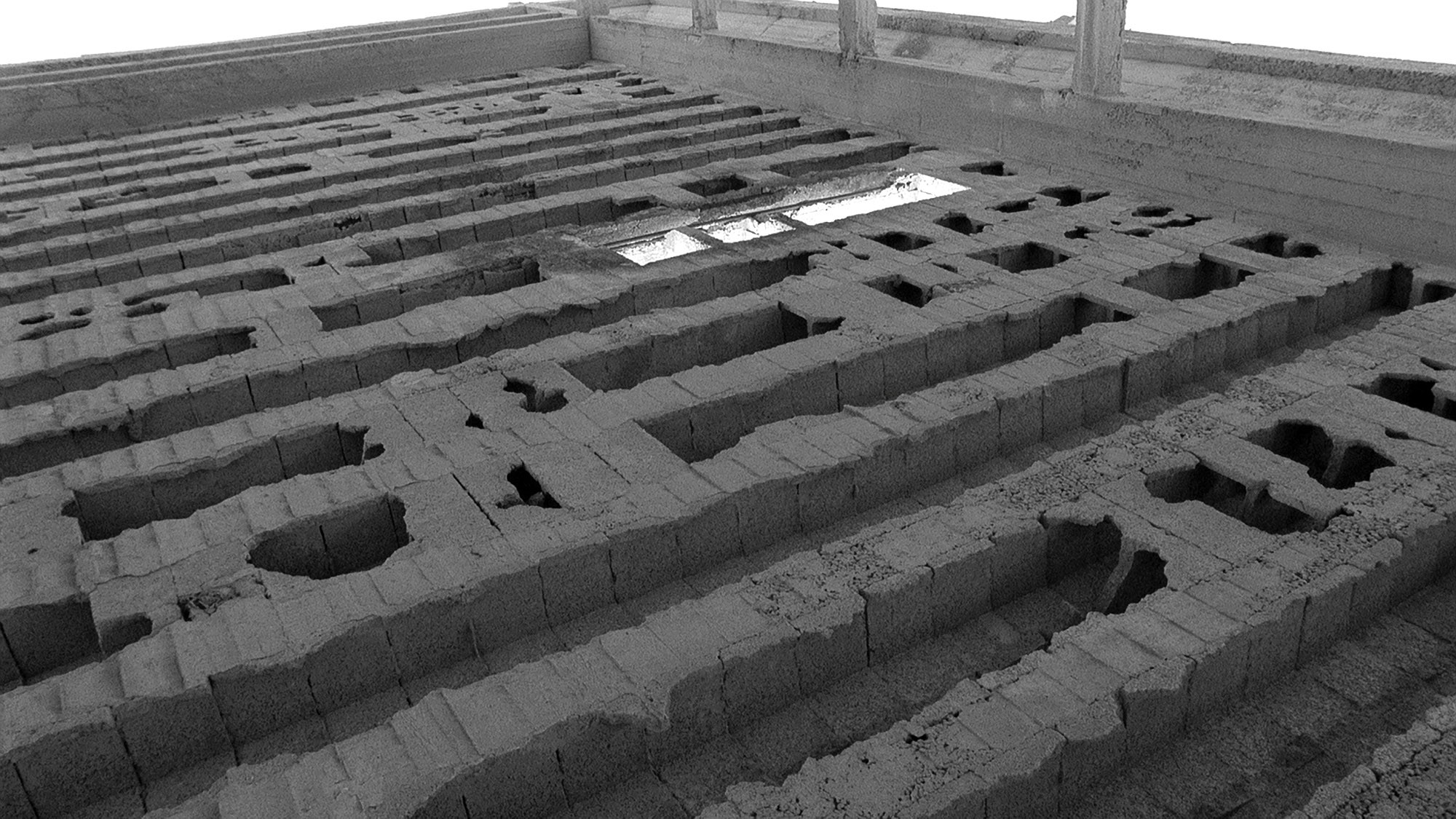 This image, from Nir Evron's 2011 film A Free Moment, depicts the mottled concrete ceiling of an uncompleted building, seen upside down as if it was the floor.