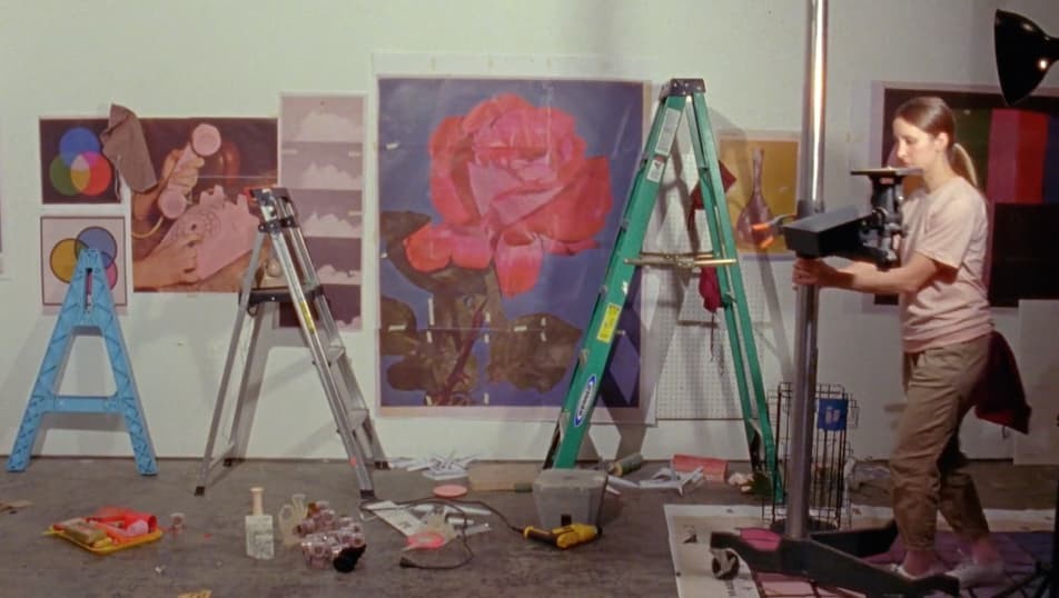A still from Sara Cwynar's 2017 film Rose Gold depicting the artist working in her studio.